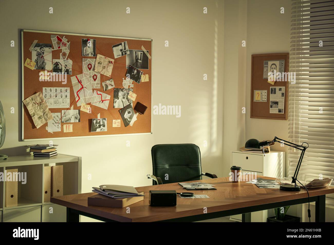 Detective workplace and evidence board in modern office Stock Photo