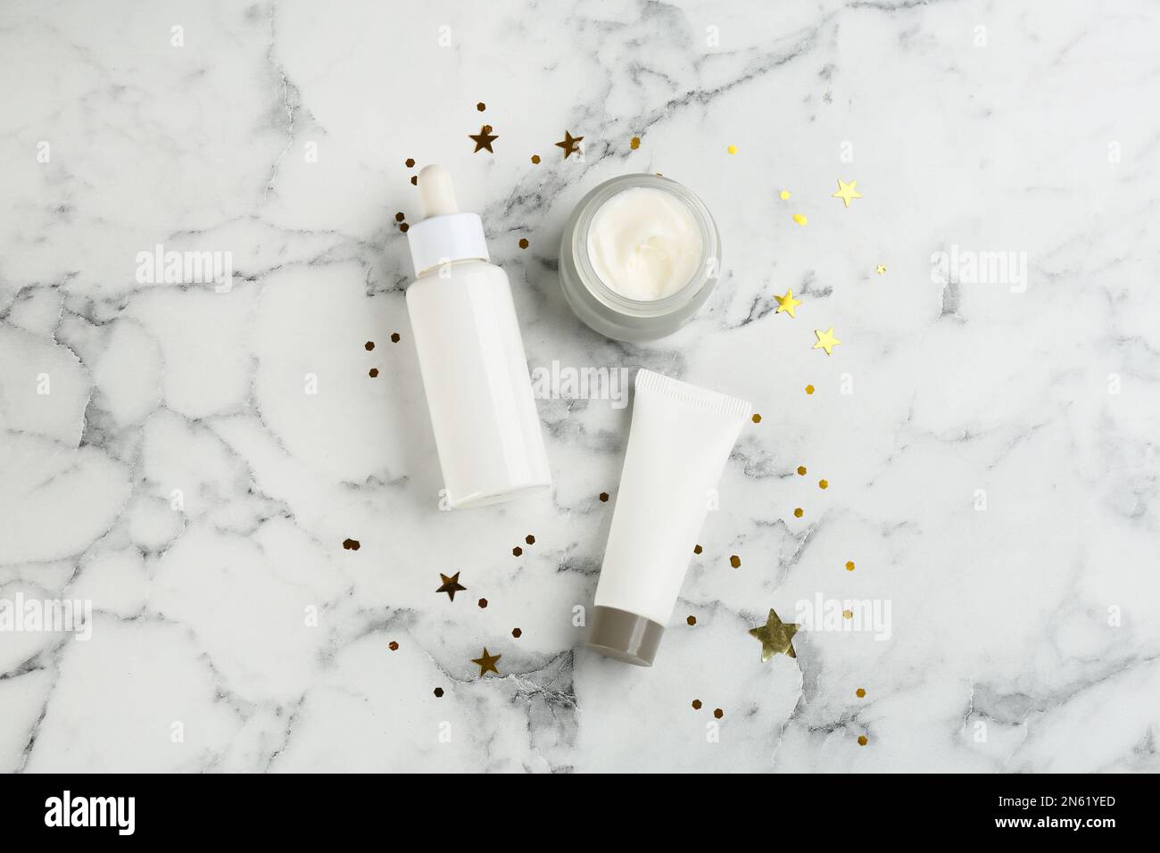 Flat lay composition with different cosmetic products on white marble ...