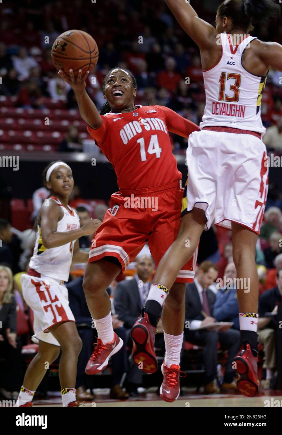 Ohio State guard Ameryst Alston (14) shoots between Maryland guard Lexie Brown, back, and center Alicia DeVaughn in the first half of an NCAA college basketball game in College Park, Md., Wednesday, Dec. 4, 2013. (AP Photo/Patrick Semansky) Stock Photo
