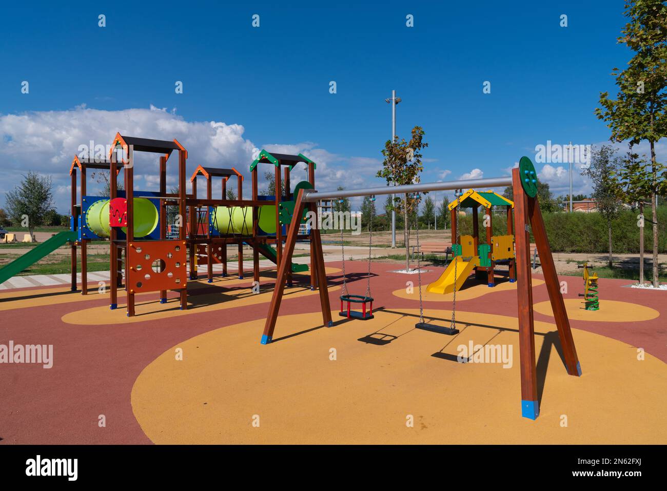 Play area outside for children with colourful swings and slides Stock Photo