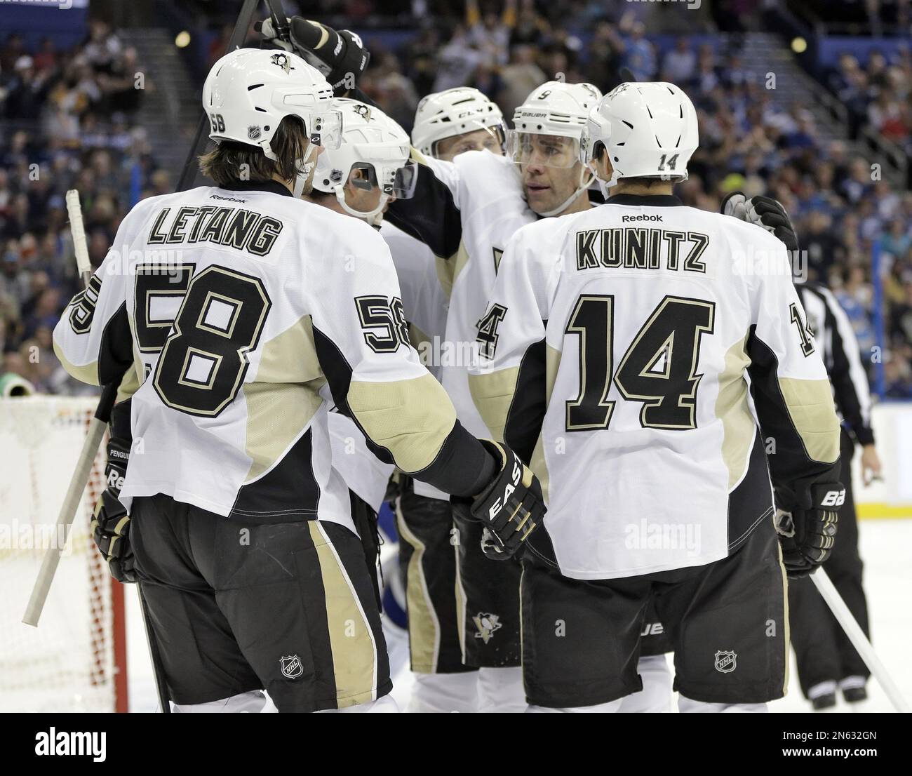 Pittsburgh Penguins left winger Chris Kunitz (14) celebrates his goal  against the Tampa Bay Lightning with teammates, including Kris Letang (58)  and Pascal Dupuis (9) during the first period of an NHL