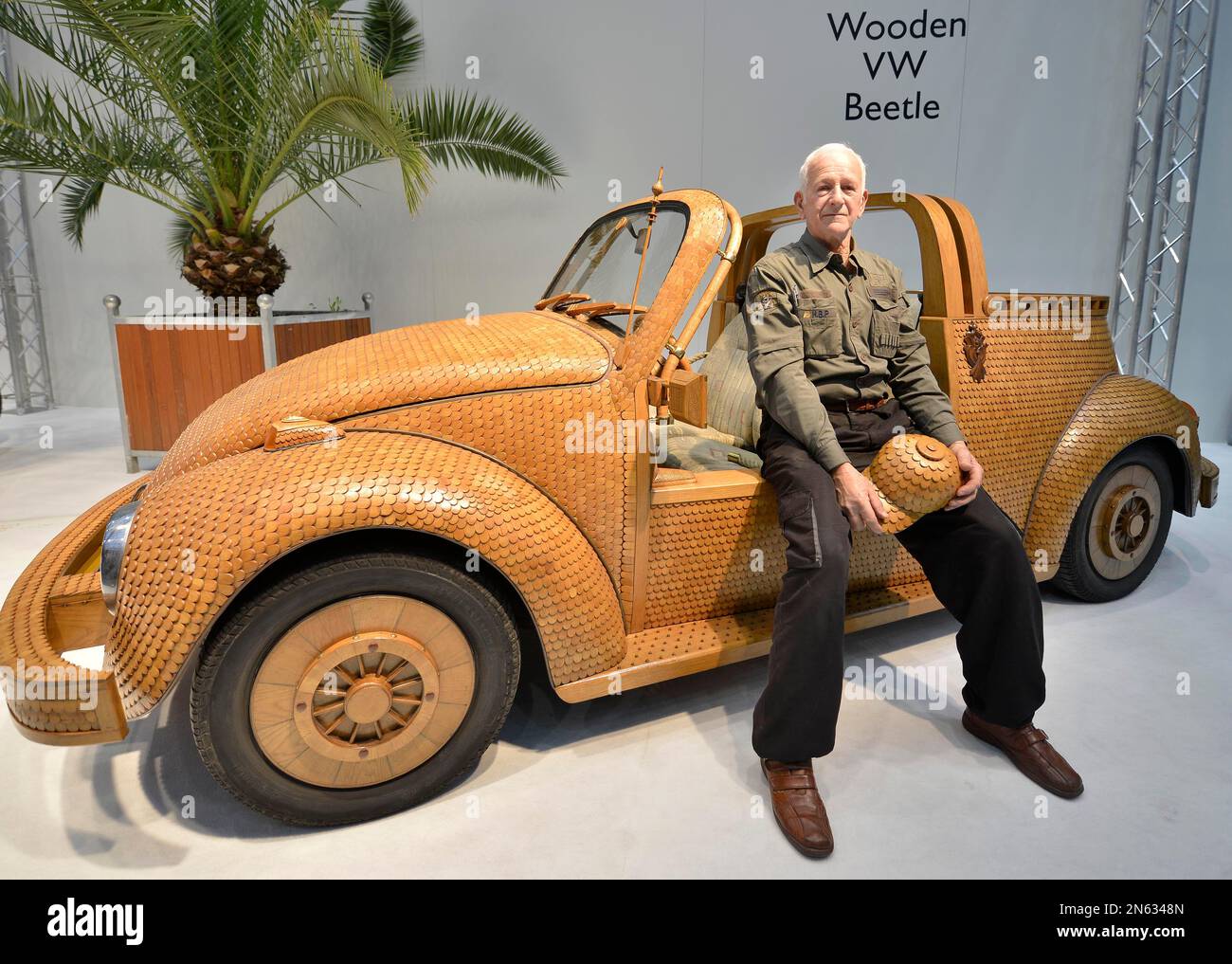 CORRECTS YEAR IN DATE -Momir Bojic from Bosnia Herzegovina sits in his  handmade wooden beetle at the opening of the Motor Show in Essen, Germany,  Friday, Nov. 29, 2013. The car is