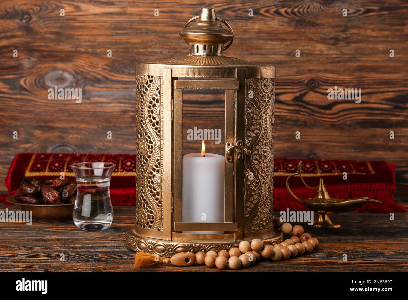 Muslim lantern with tasbih, dates and glass of water for Ramadan on ...