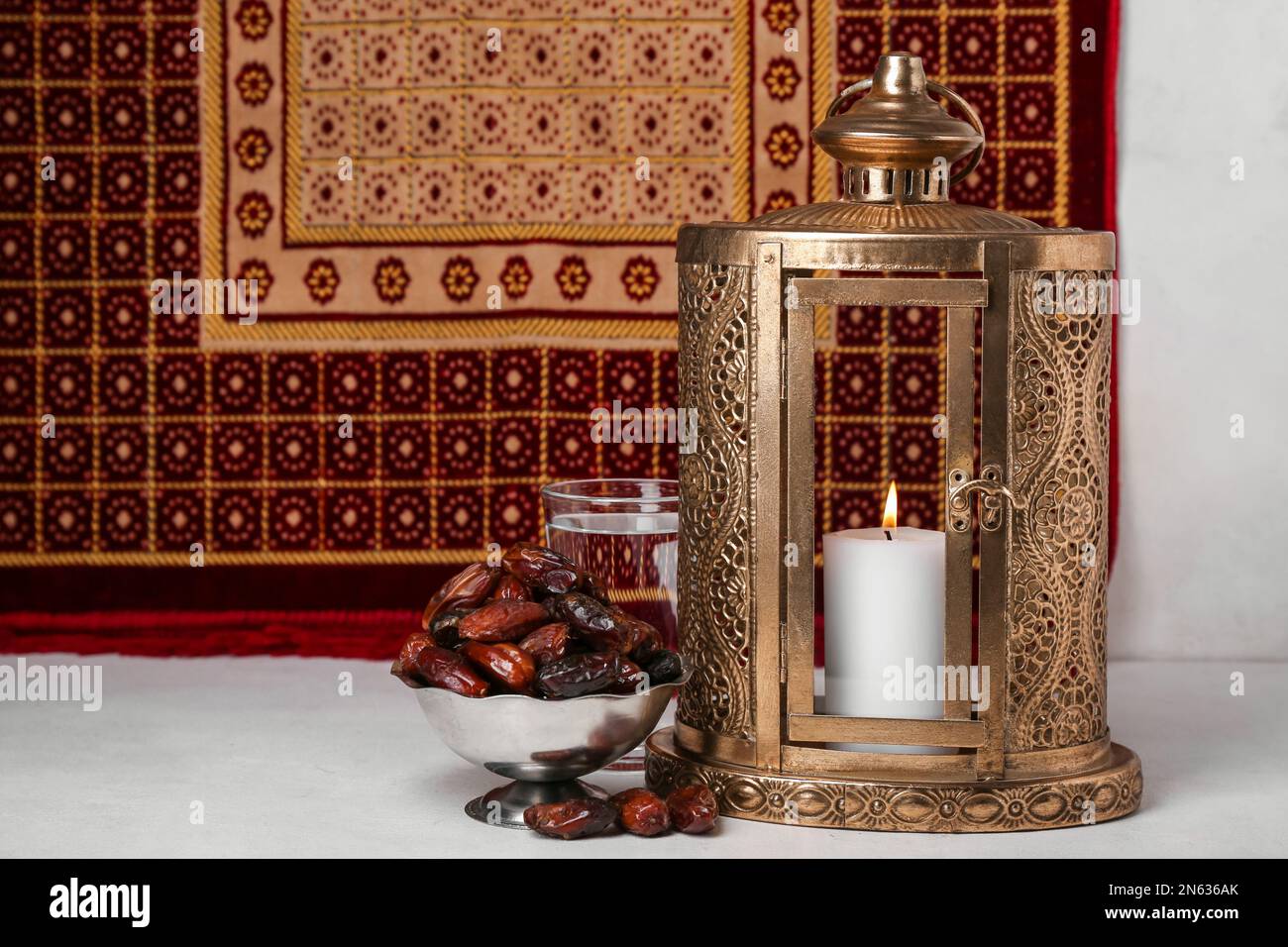 Muslim lantern with dates and glass of water for Ramadan on table Stock ...