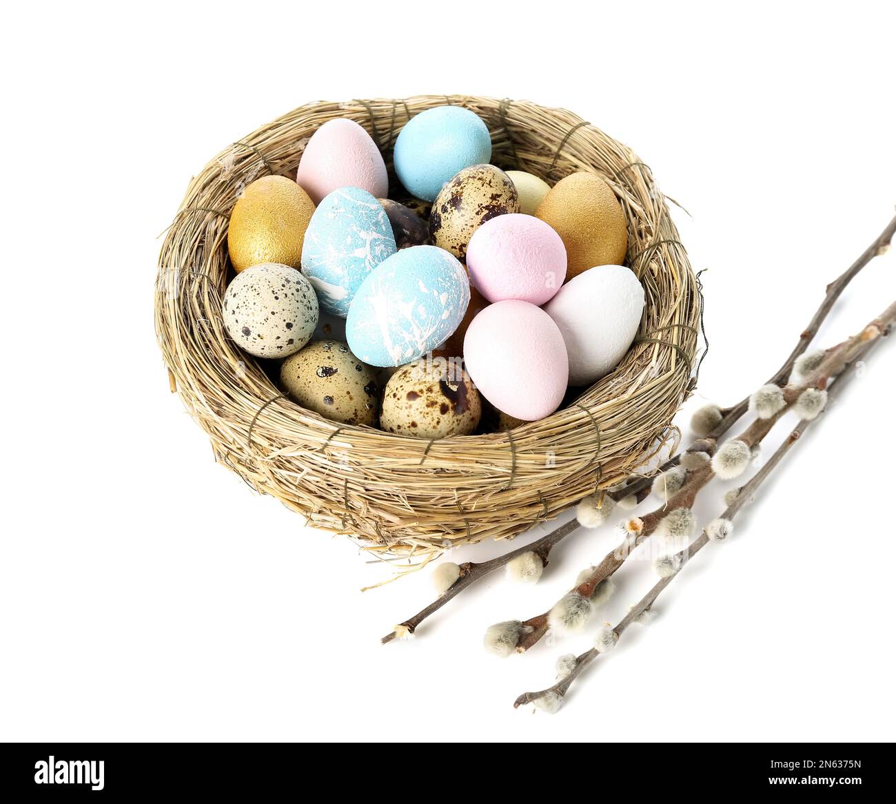 Nest with beautiful Easter eggs and willow branches on white background ...