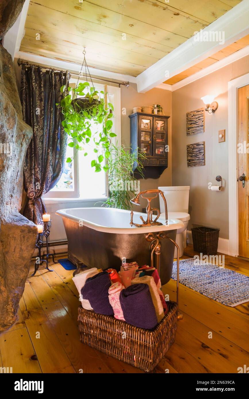 Freestanding rolltop bathtub with antique copper finish hardware