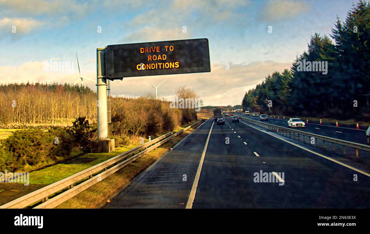 drive to road conditions  motorway sign message on the M8 Stock Photo