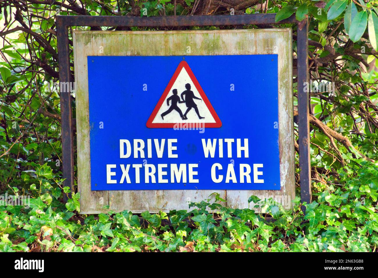 drive with extreme care road warning sign Stock Photo