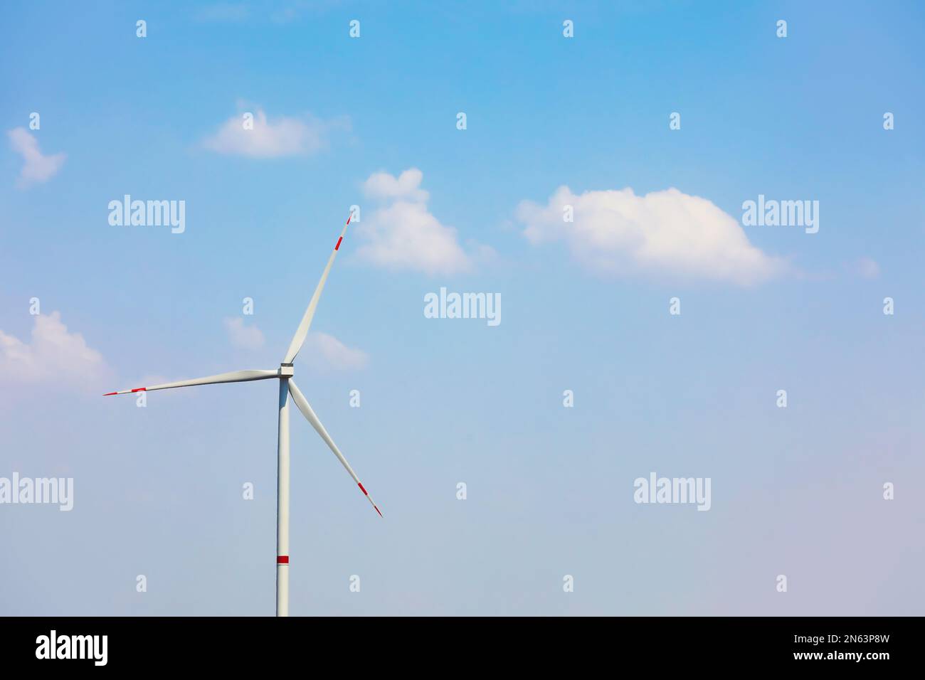 Modern wind turbine against blue sky. Energy efficiency Stock Photo