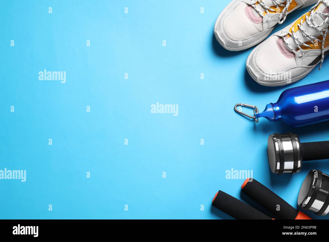 Flat lay composition with sport items on blue background. Space for text Stock Photo