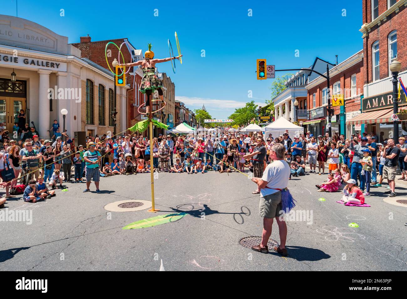 Crowd enjoys a busker show during the Buskerfest in downtown Dundas, Ontario, Canada. Stock Photo