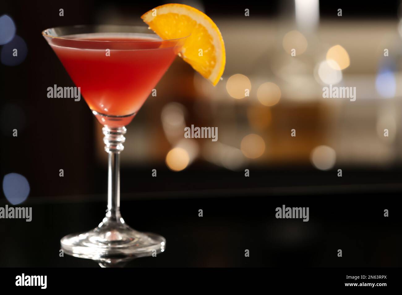 Delicious cocktail with orange on bar counter. Space for text Stock Photo