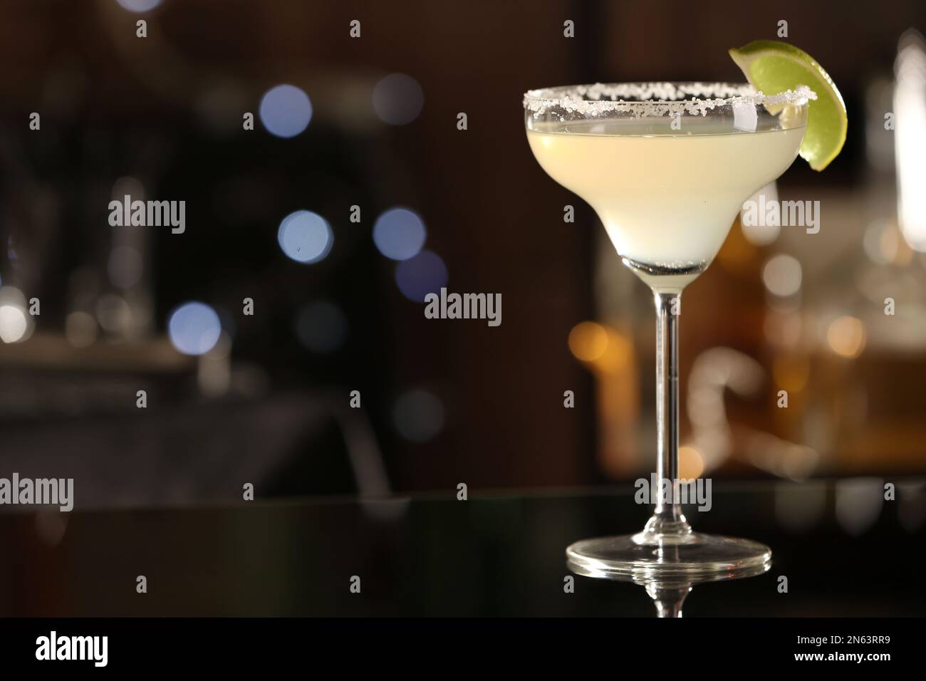 Delicious cocktail with lime and sugar on bar counter. Space for text Stock Photo