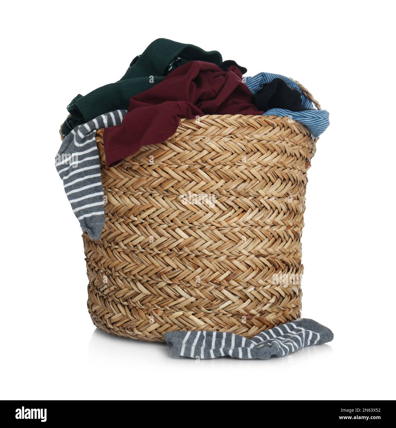 Wicker laundry basket with clothes isolated on white Stock Photo