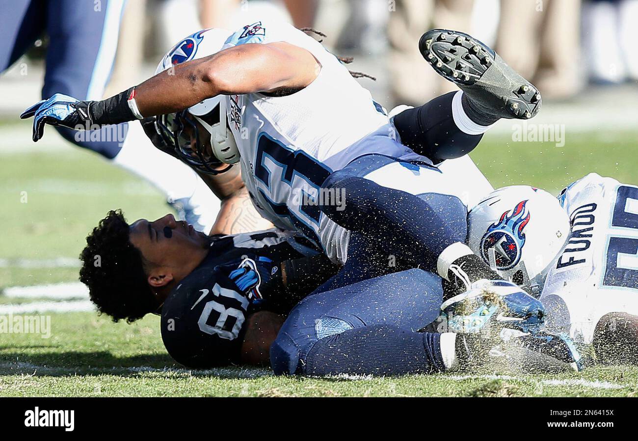 Oakland Raiders tight end Mychal Rivera 81 loses his helmet as he is hit by Tennessee Titans free safety Michael Griffin 33 during the second quarter of an NFL football game in