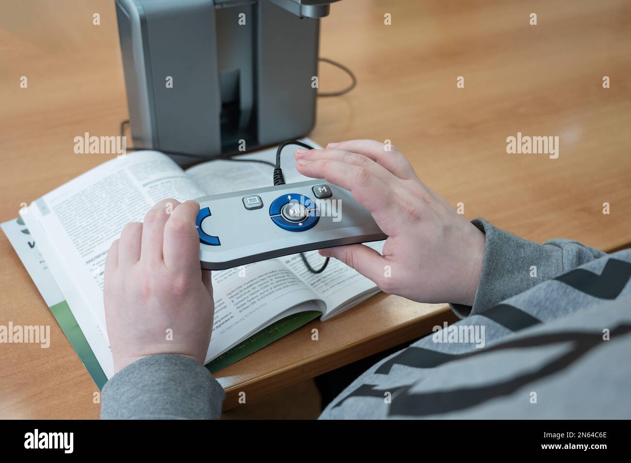 A visually impaired man uses a scanning and reading machine Stock Photo