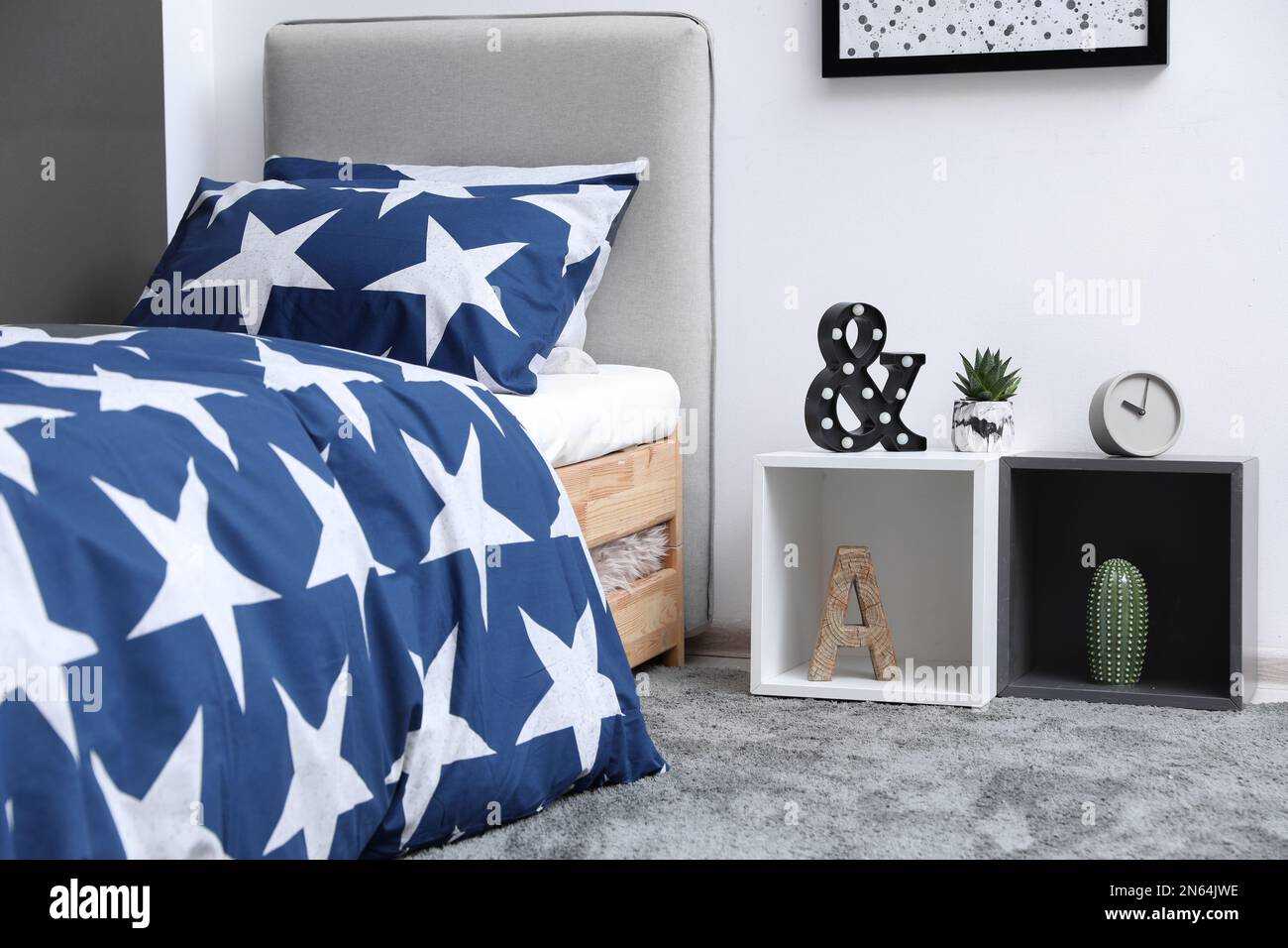 Bed with stylish linens in children's room Stock Photo Alamy