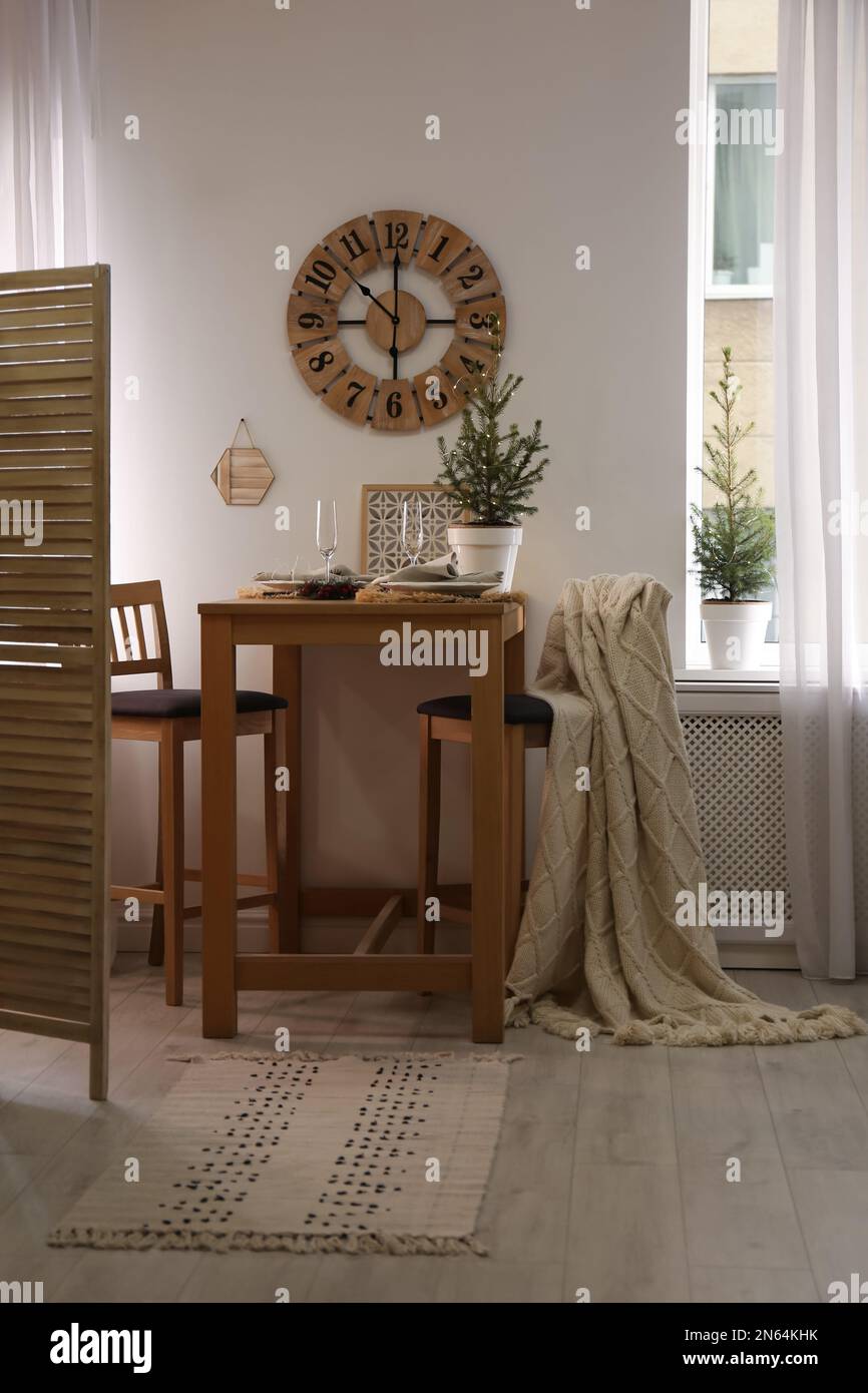 Small potted fir trees in dining room. Interior design Stock Photo - Alamy