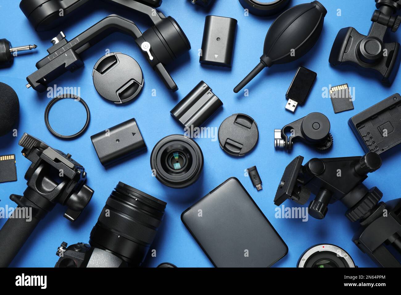 Flat lay composition with camera and video production equipment on blue ...