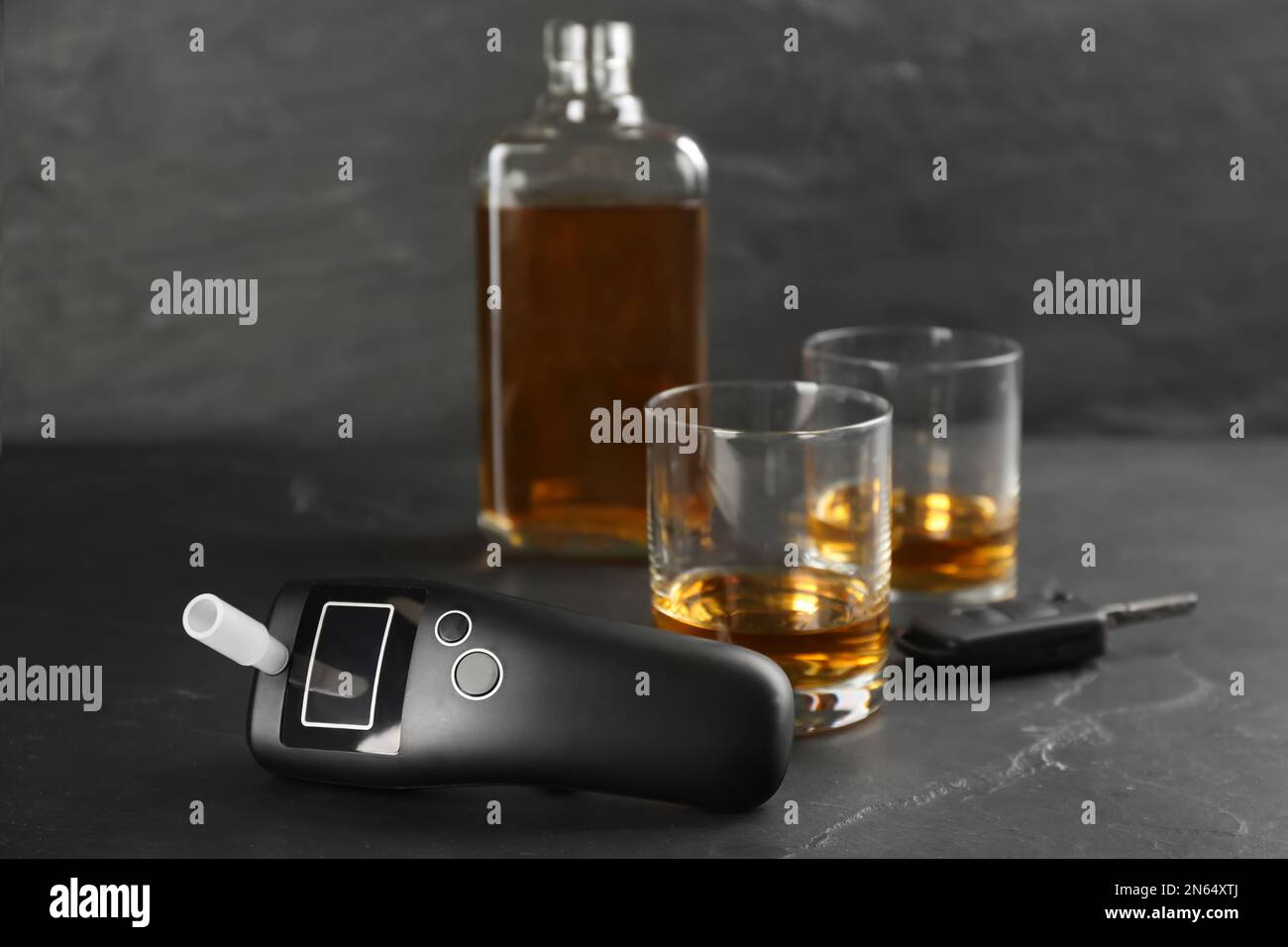 Modern breathalyzer, car key and alcohol on black table Stock Photo Alamy
