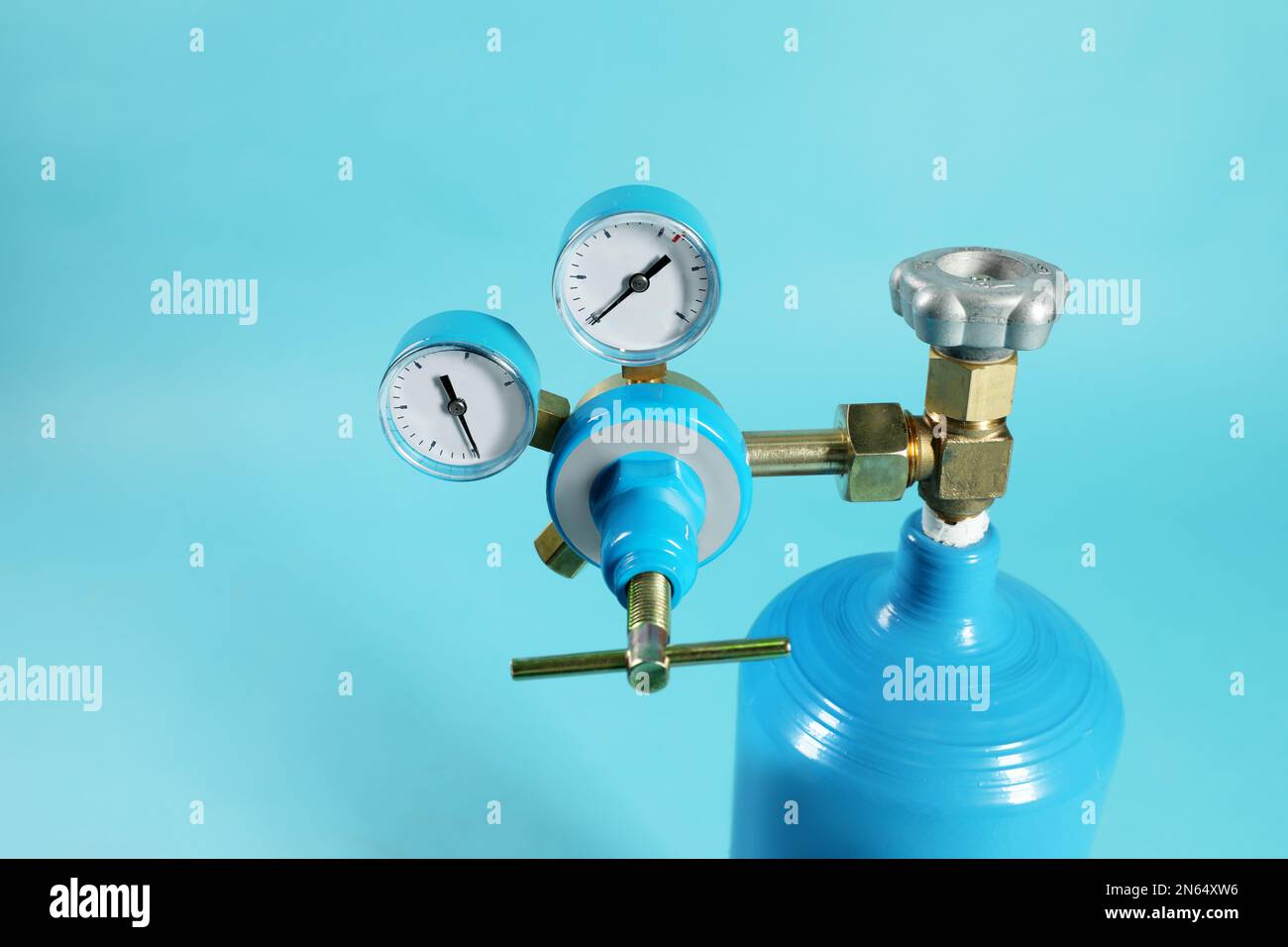 Oxygen tank on light blue background, closeup. Medical equipment Stock
