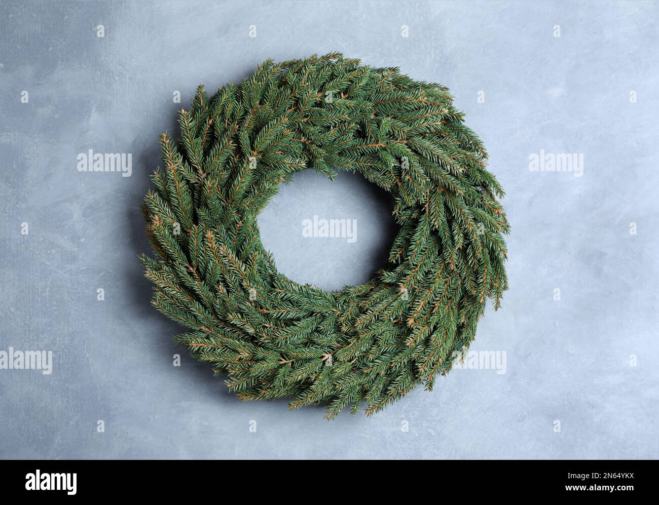 Christmas wreath made of fir branches on color wall Stock Photo - Alamy