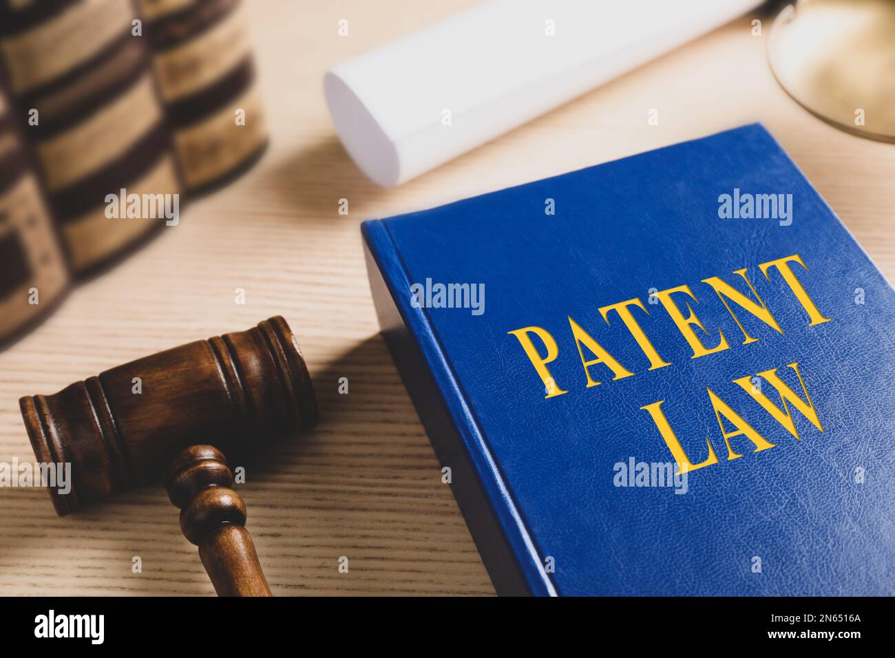 Patent Law book and gavel on wooden table Stock Photo