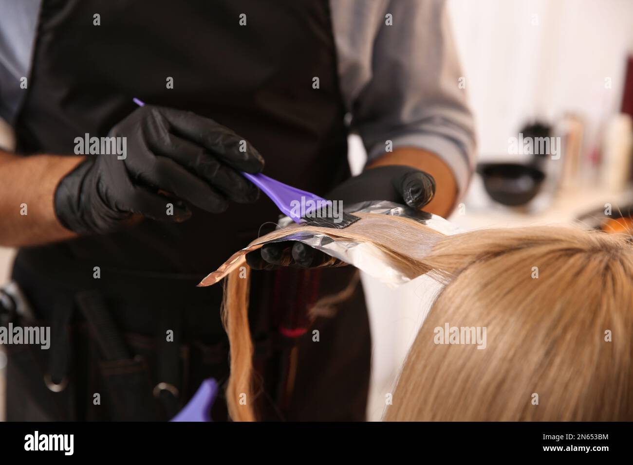 Woman coloring her hair with foil in beauty salon Stock Photo - Alamy