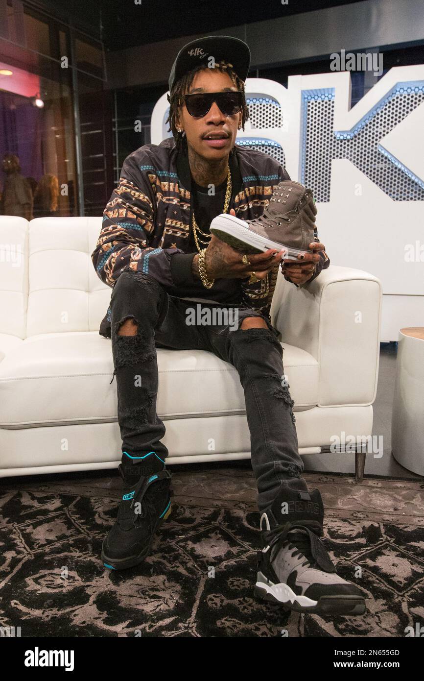 Recording artist Wiz Khalifa poses with one of his new Converse ...