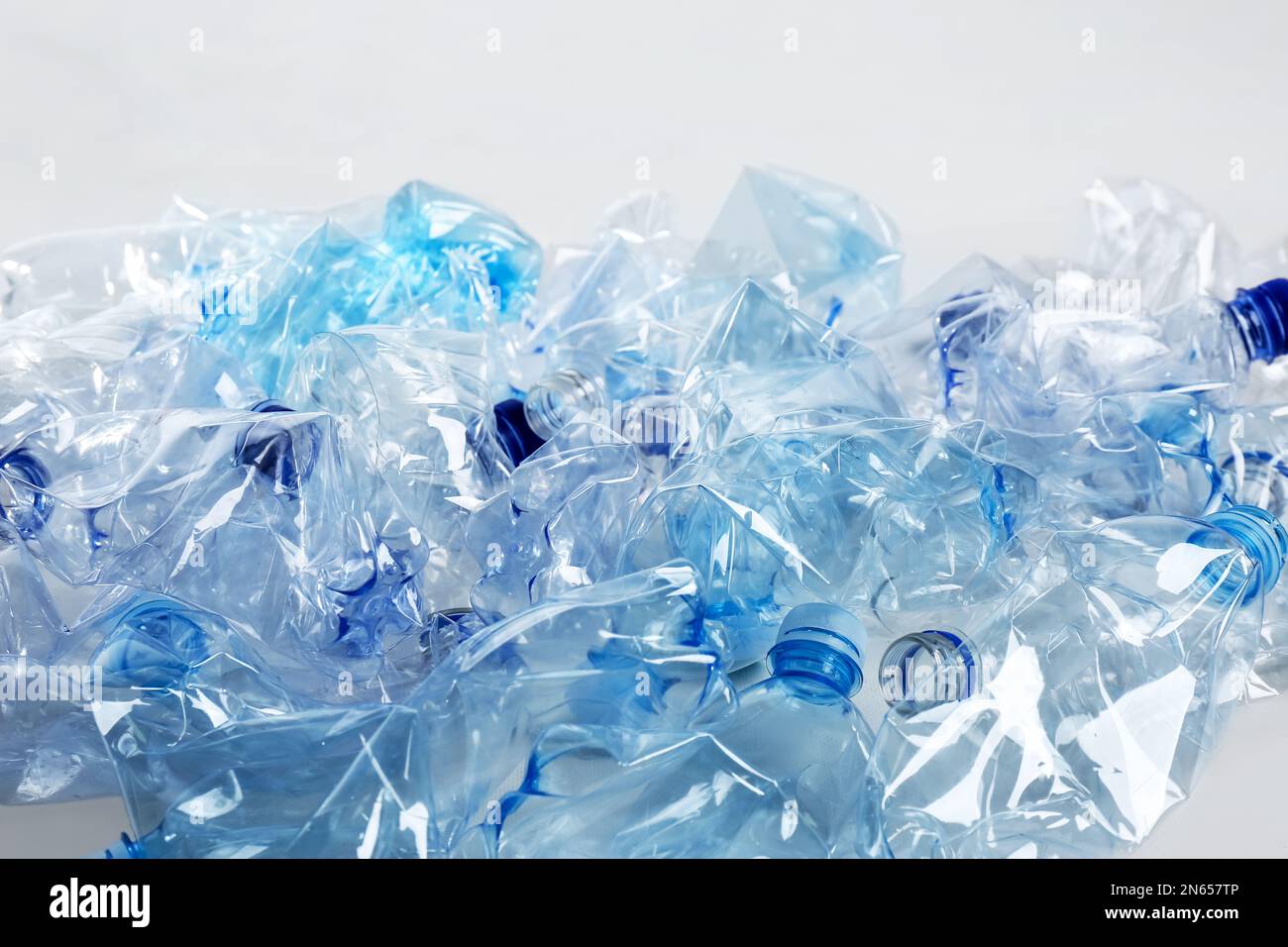 Curated visual reference: Fresh Look at Heap Of Used Plastic Bottles On White Background Recycling Problem