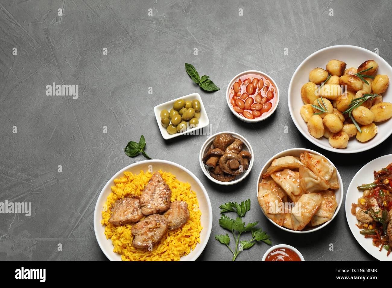 Buffet service. Flat lay composition with many different dishes on grey  table, space for text Stock Photo - Alamy