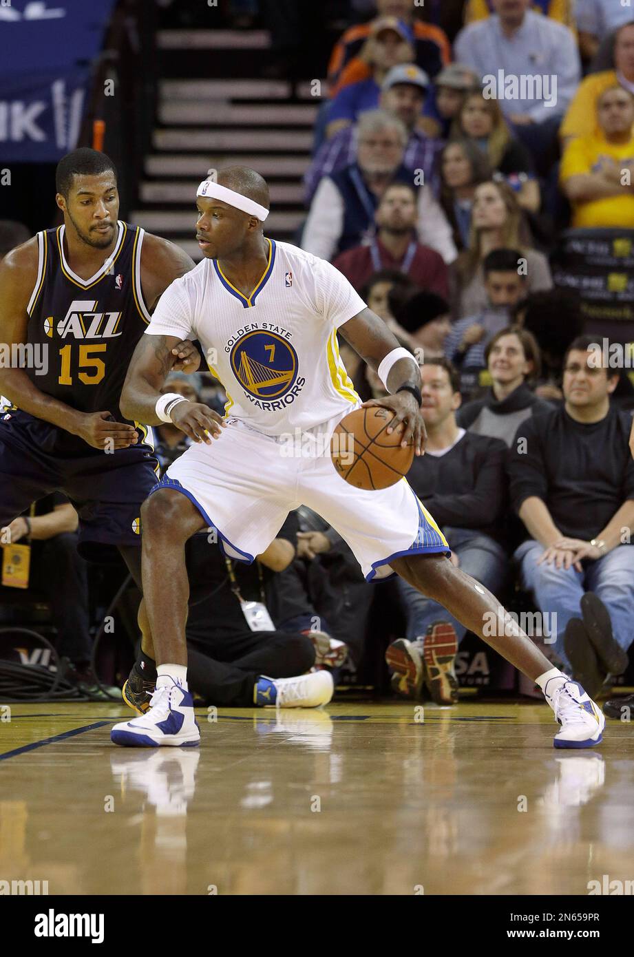 Golden State Warriors center Jermaine O Neal 7 drives on Utah Jazz power forward Derrick Favors 15 during an NBA basketball game in Oakland Calif. Saturday Nov. 16 2013. AP Photo Jeff Chiu Stock