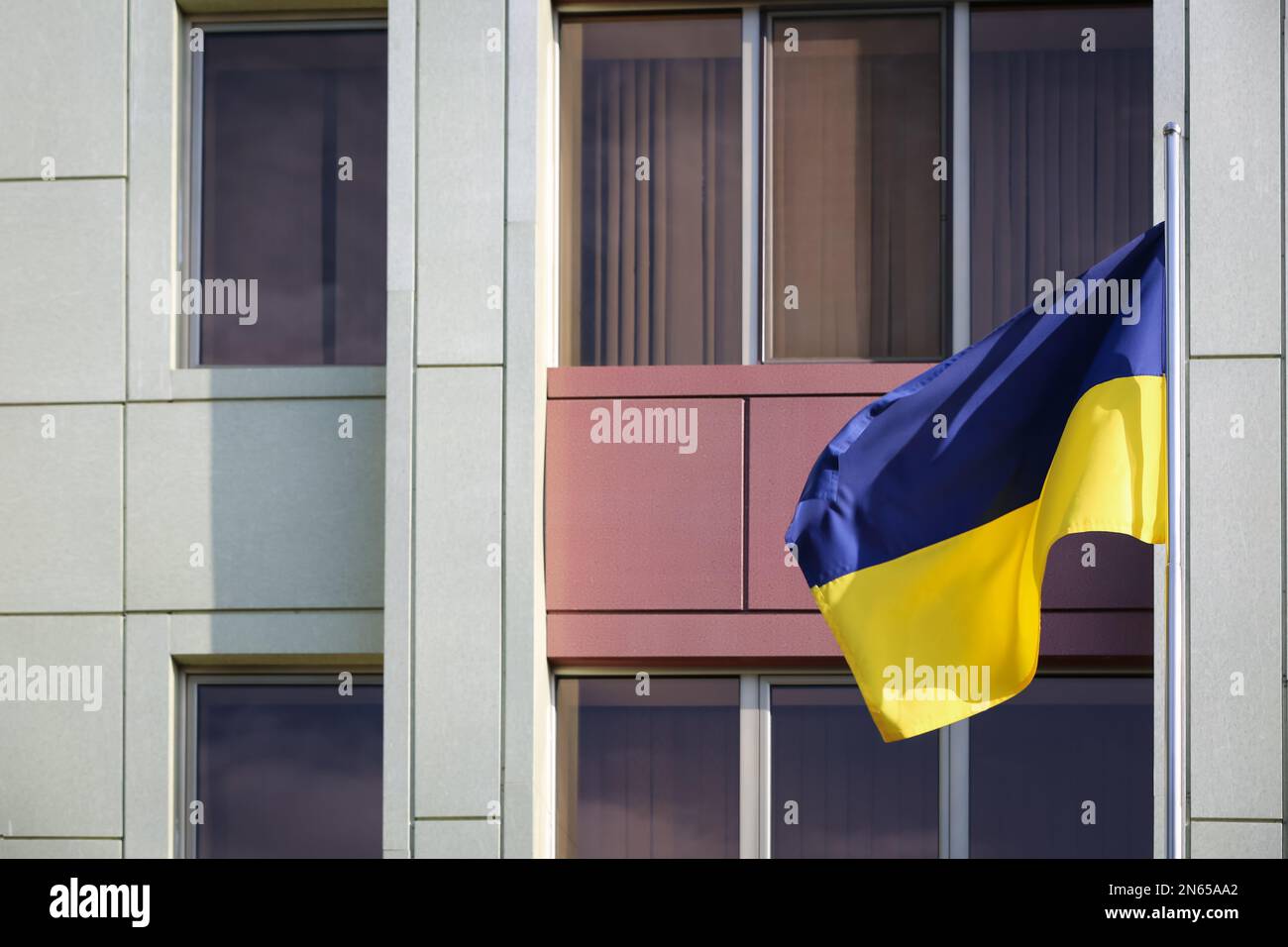 Ukrainian flag and modern building on background Stock Photo