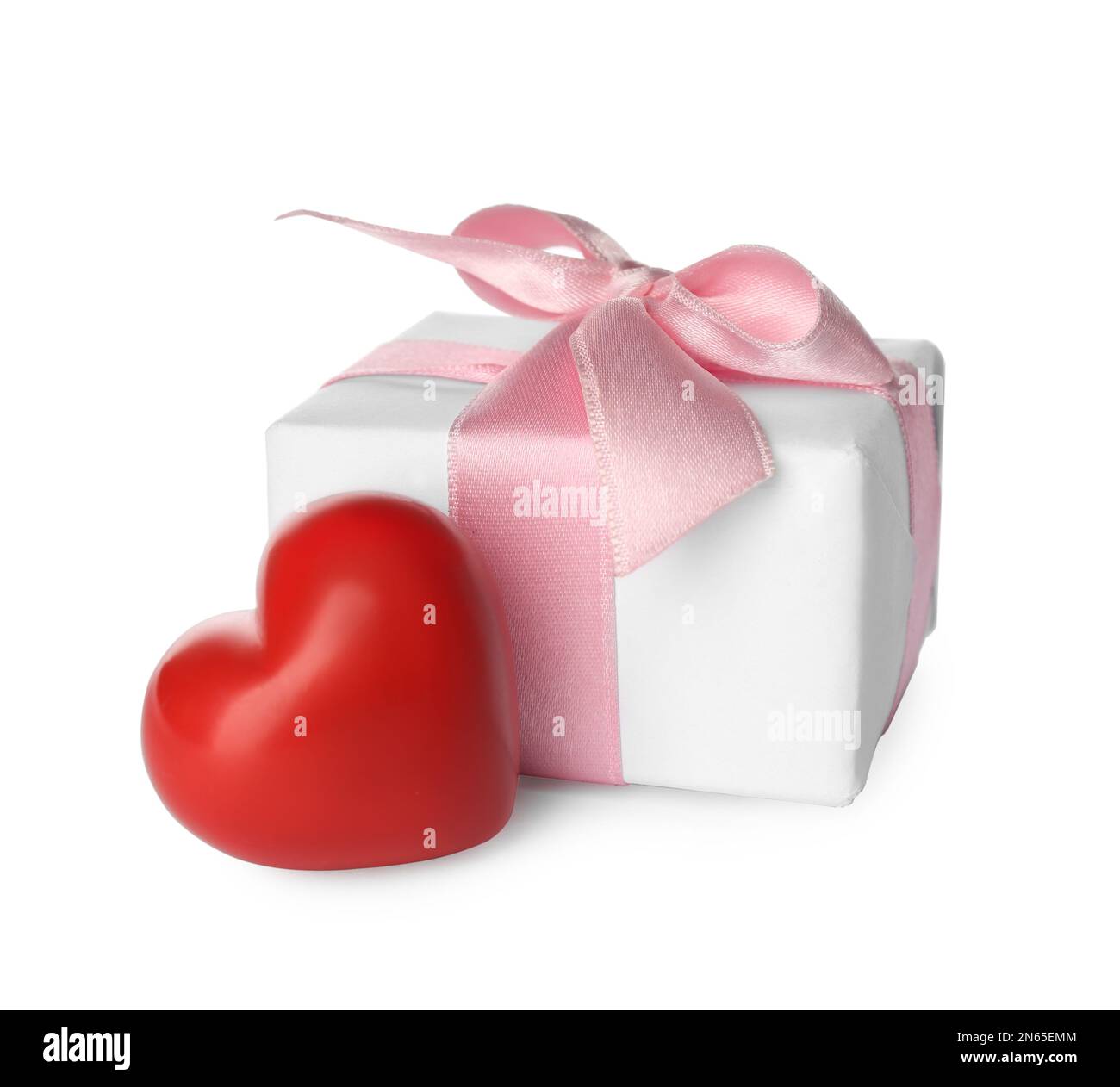 Beautiful gift box and red heart on white background. Valentine's day celebration Stock Photo