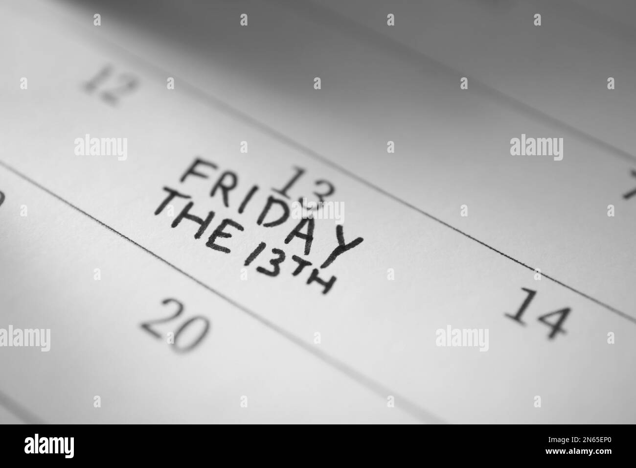 Calendar page with phrase Friday The 13th, closeup. Superstition of bad