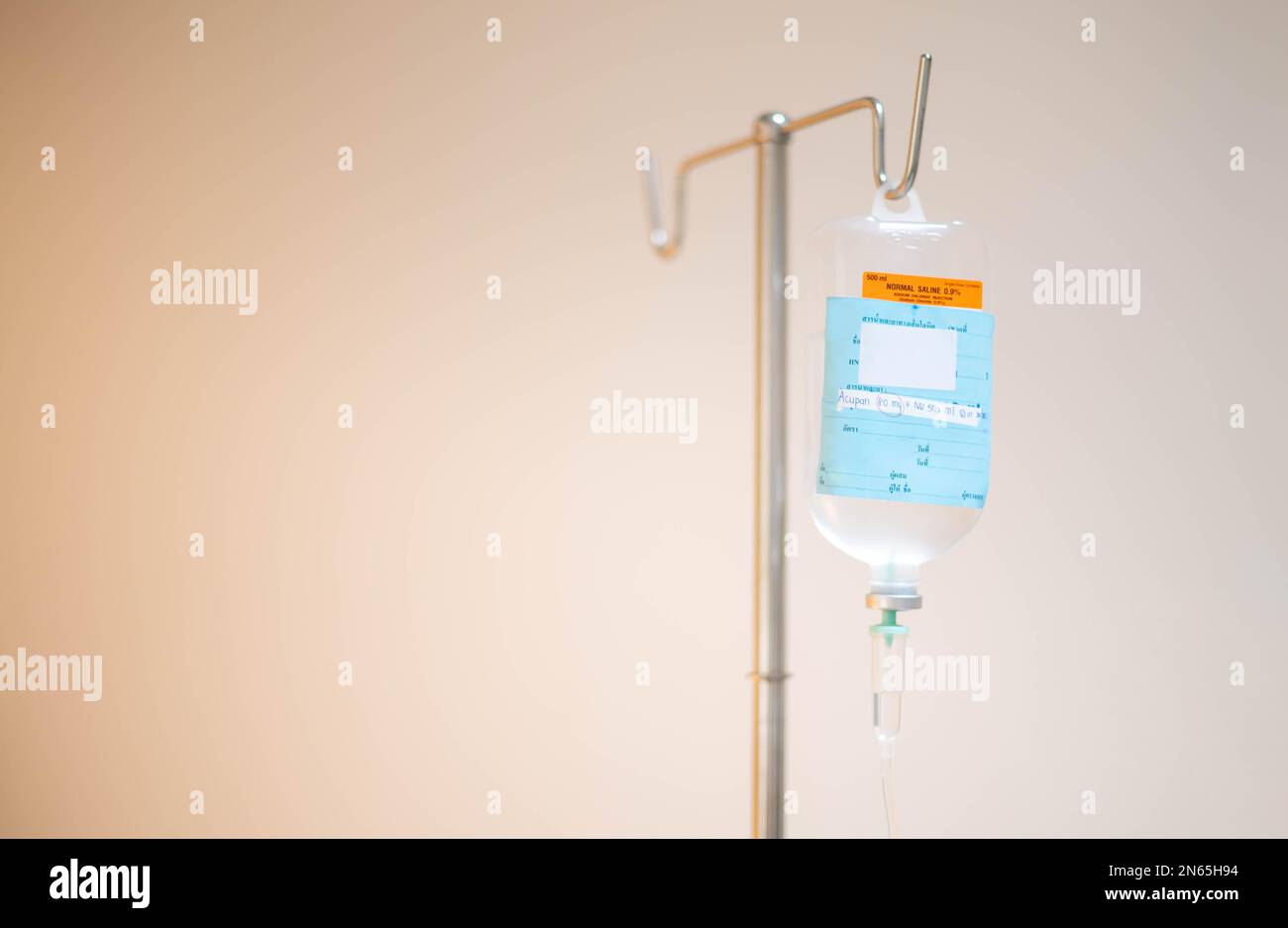 The saline bag hanging on the IV pole in the emergency room at the hospital. Stock Photo