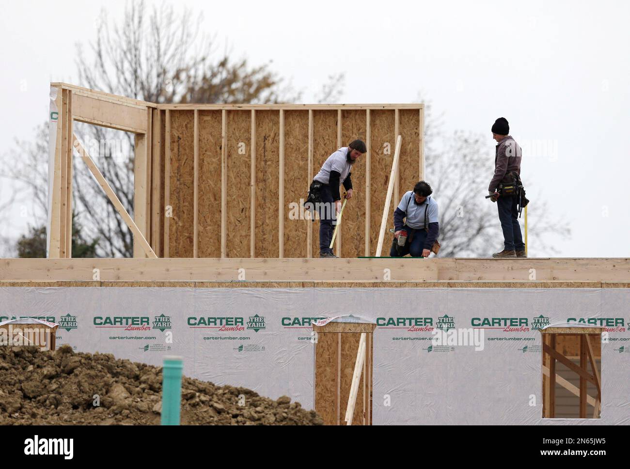 In this Monday, Nov. 11, 2013, photo, workers build a new home in Pepper Pike, Ohio. National
