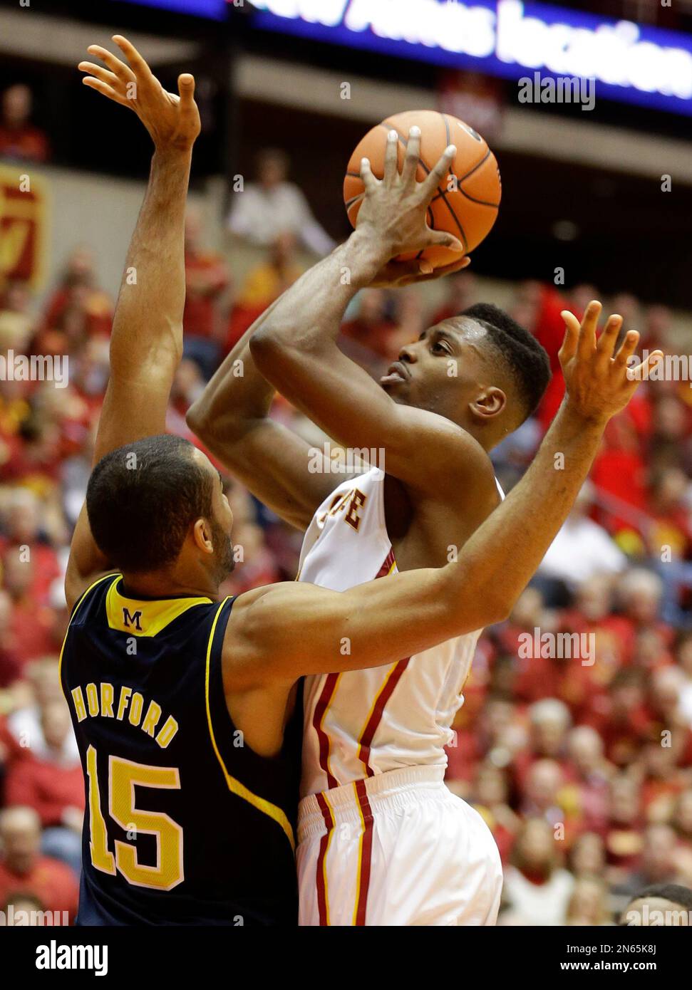 Iowa State forward Melvin Ejim, right, shoots over Michigan forward Jon