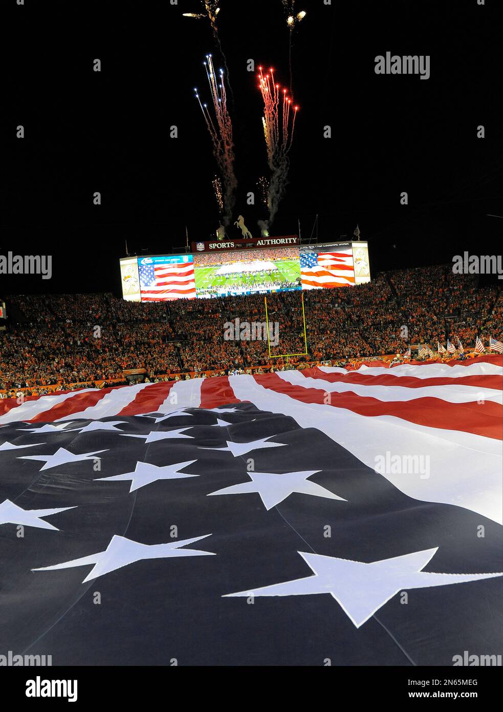 A giant United States flag is stretched across the outfield of