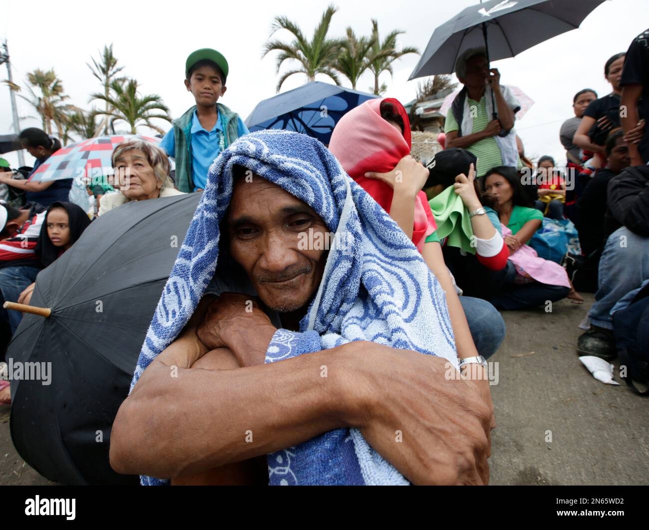 Typhoon survivor Mario Barbado, 56, waits for a chance to board any