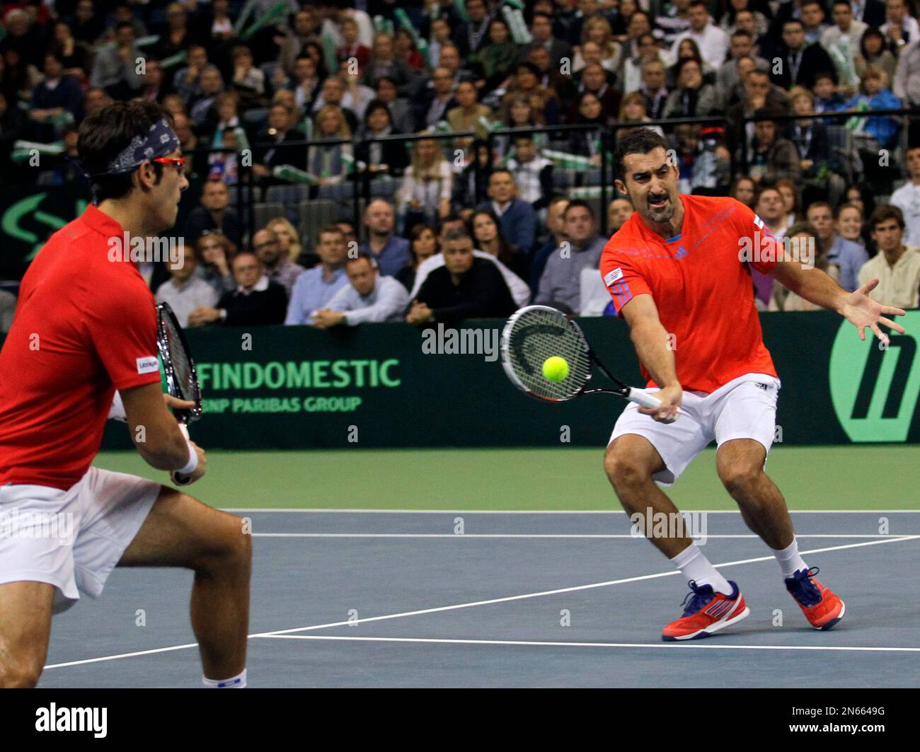 Serbia's Nenad Zimonjic, right, returns a ball as his partner Ilija  Bozoljac looks on during their Davis Cup finals doubles tennis match  against Tomas Berdych and Radek Stepanek of Czech Republic, in