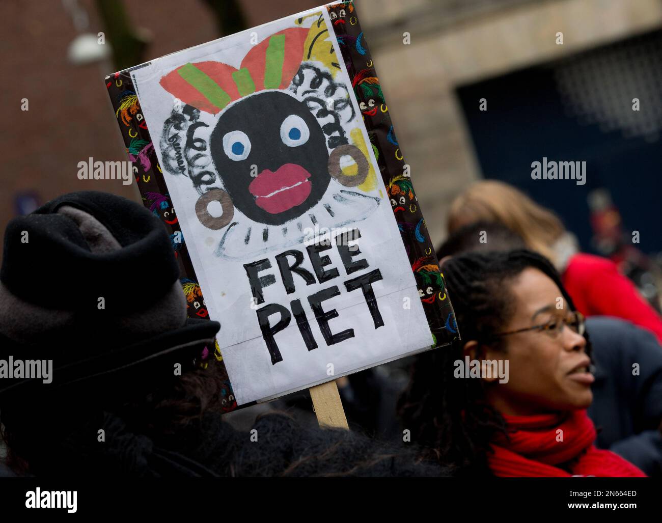 A woman holds a placard during a demonstration against "Zwarte Piet" or