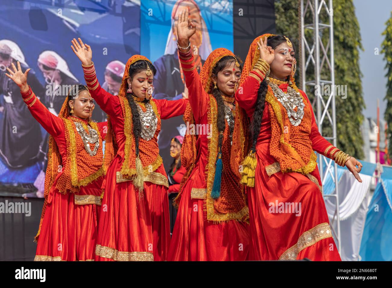 Tribal women of Uttarakhand wearing traditional attire dancing in their
