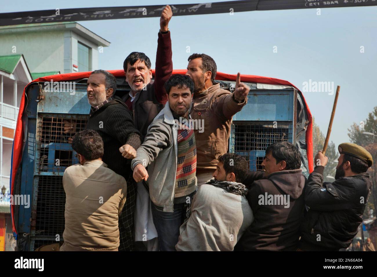 Kashmiri Shiite Muslims shout religious slogans from inside a police ...