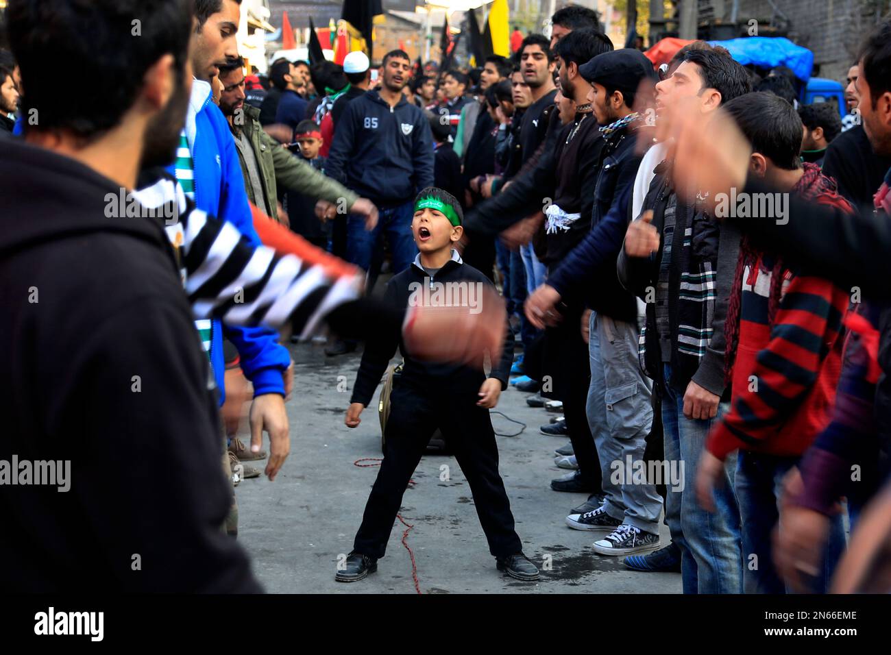 A young Kashmiri Shiite Muslims shout religious slogans, during a ...