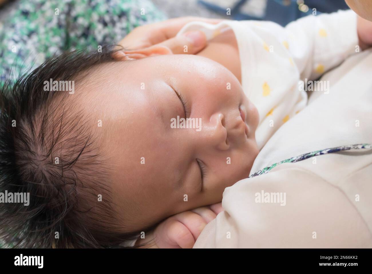 Baby sleeping on mother's chest, 1 month old, Niiza city, Saitama