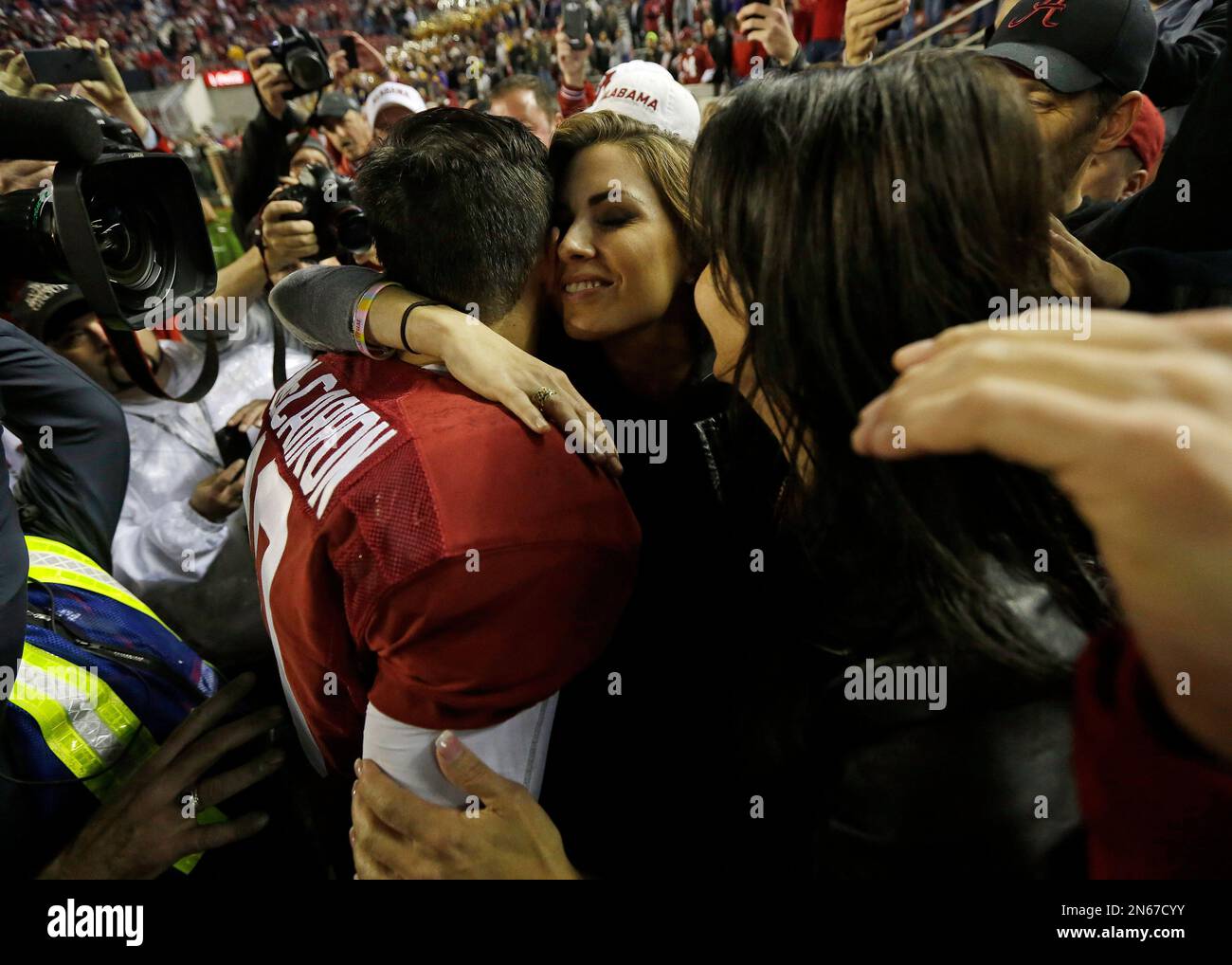 Alabama quarterback AJ McCarron embraces his girlfriend Katherine Webb, as  his mother Dee Dee Bonner, right looks on after the second half of an NCAA  college football game against LSU, Saturday, Nov.
