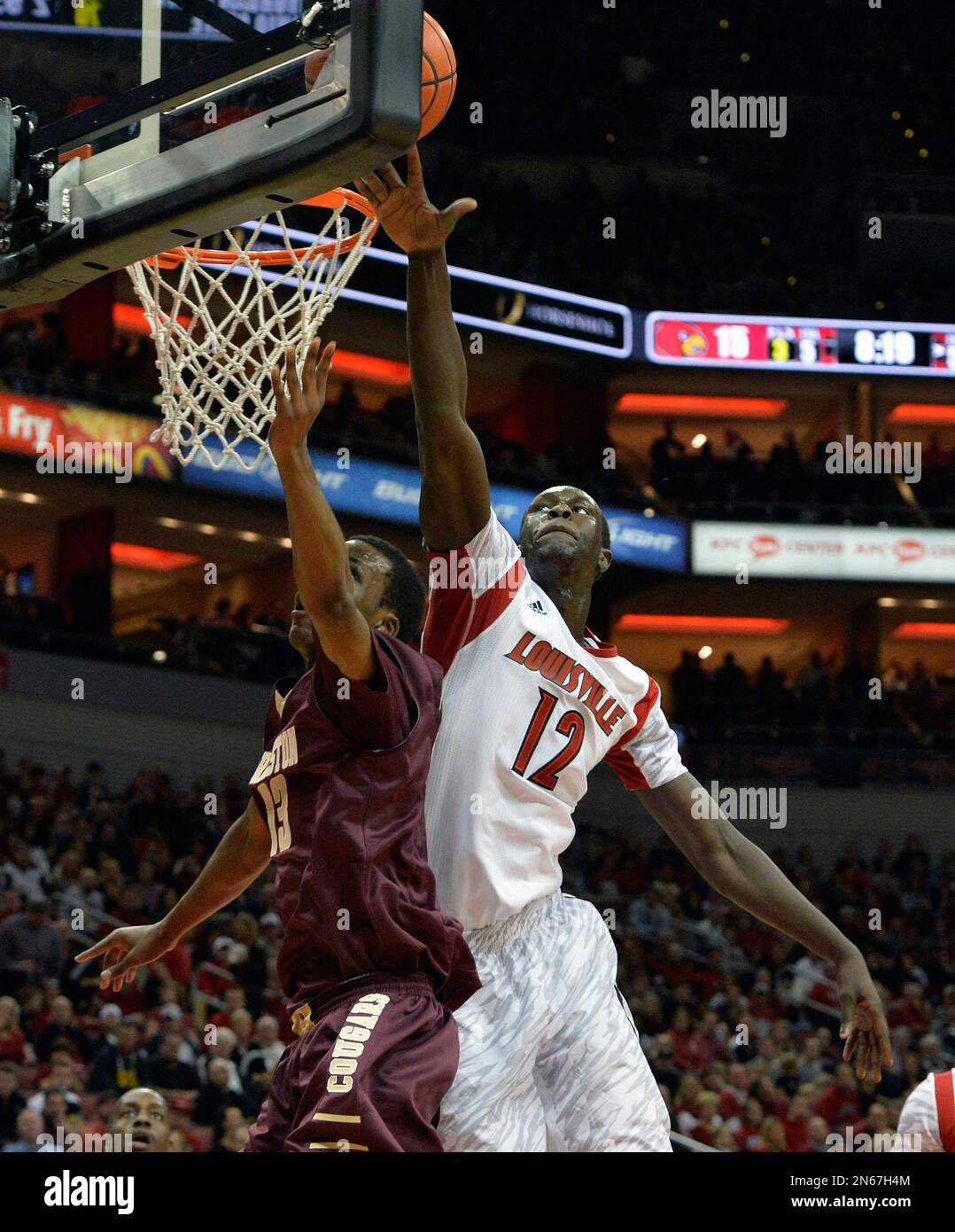 Louisville's Mangok Mathiang, right, attempts to block the shot of the