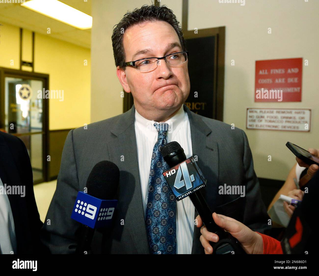 Prosecutor Jason Hicks talks with the media after upgrading charges