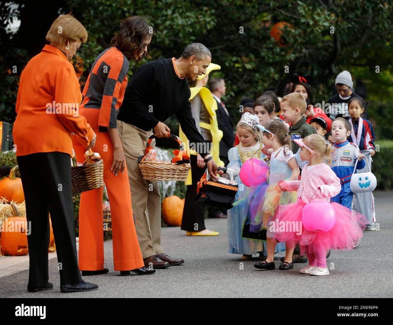 President Barack Obama, center, first lady Michelle Obama and her